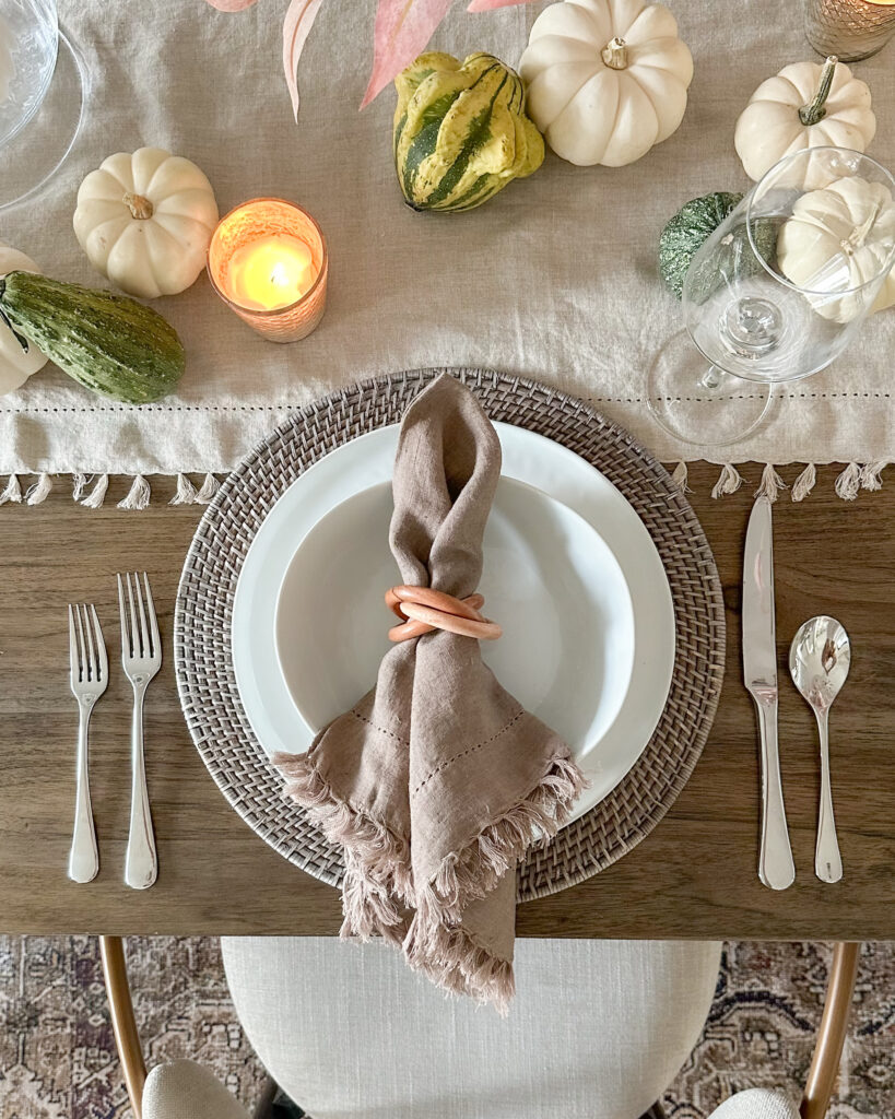 Celebrating in Style: Thanksgiving Tablescapes, Fashion Finds & More | fall tablescape, dining room, thanksgiving tablescapes, thanksgiving decor, holiday decor, candle holders, plates, placemats, napkin rings, wine glasses