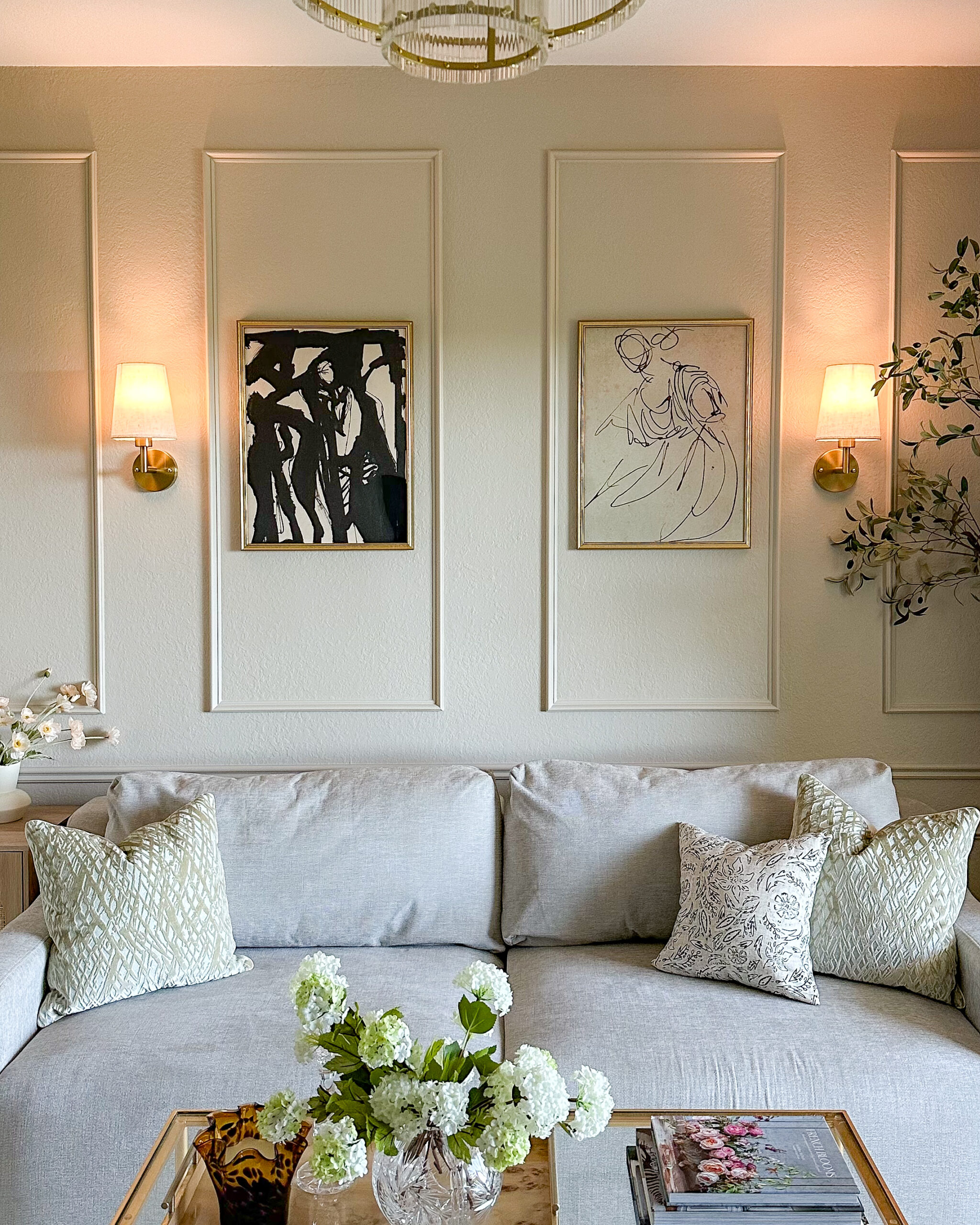 Lighting Fixture Favorites To Brighten Up Your Home | living room lighting, wall sconces, wall lights, artwork, modern living room, marble, chandelier, wireless sconces