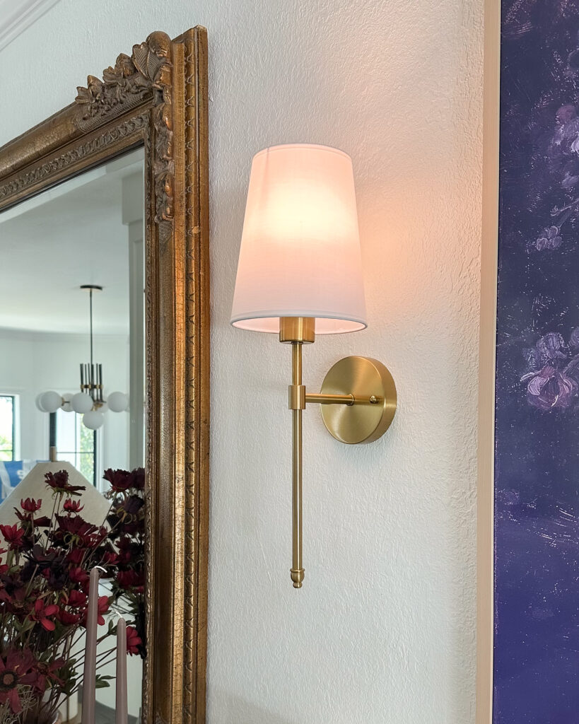 Lighting Fixture Favorites To Brighten Up Your Home | living room lighting, wall sconces, wall lights, artwork, modern living room, marble, chandelier, wireless sconces